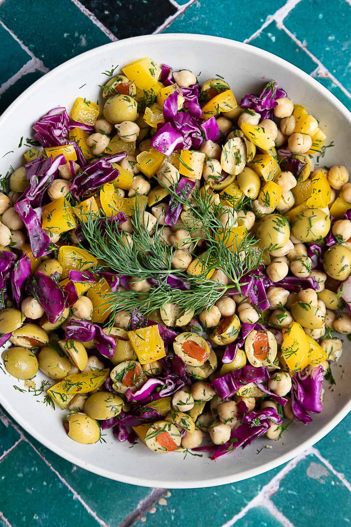 Mediterranean Chickpea Salad Mediterranean chickpea salad served in a large white bowl with dill as garnish