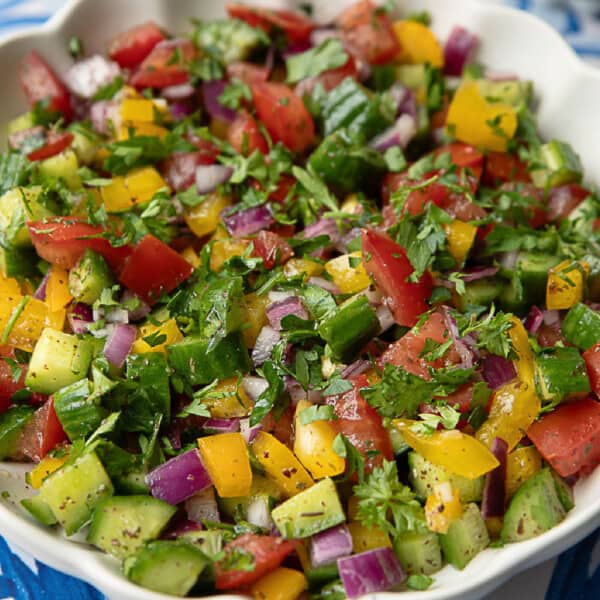a close-up view of Middle Eastern chopped salad in a white serving bowl