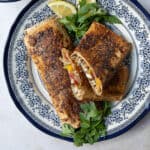 balik ekmek or Turkish street food fish sandwich served on a decorative blue and white plate
