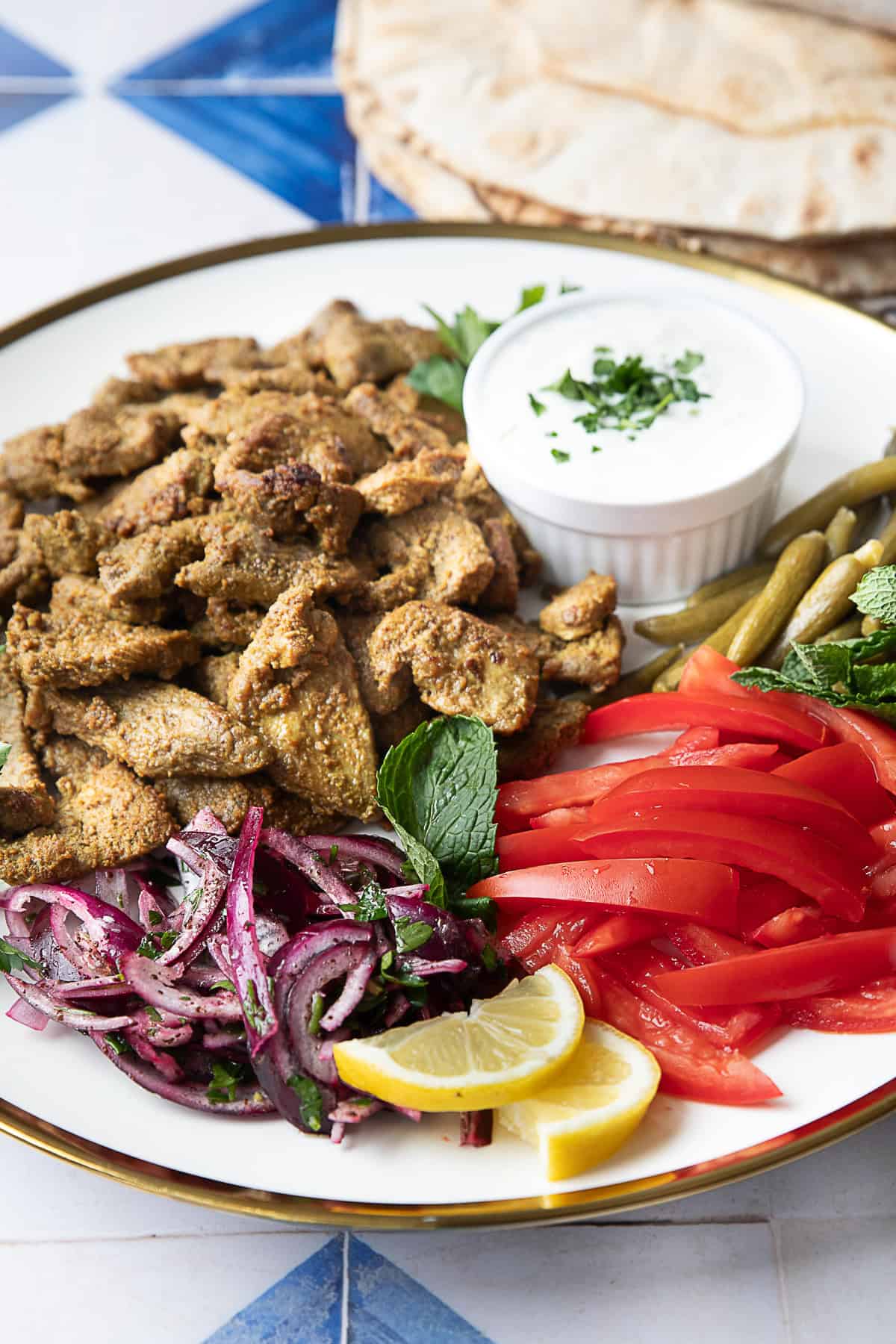 How to Make Seared Lamb Shawarma seared lamb shawarma on a plate with fixings