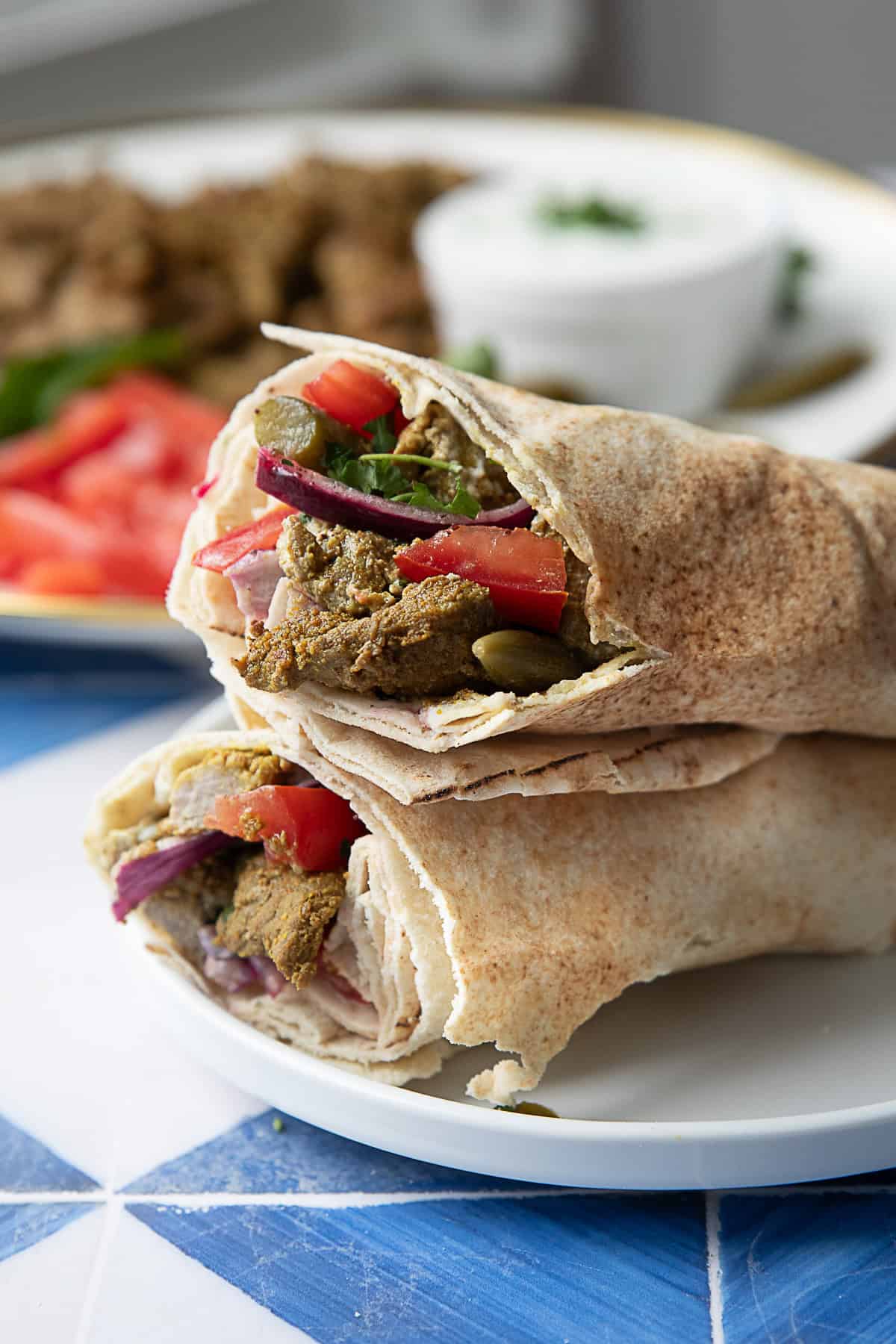 Seared Lamb Shawarma Wrap lamb shawarma served in a pita wrap with fixings