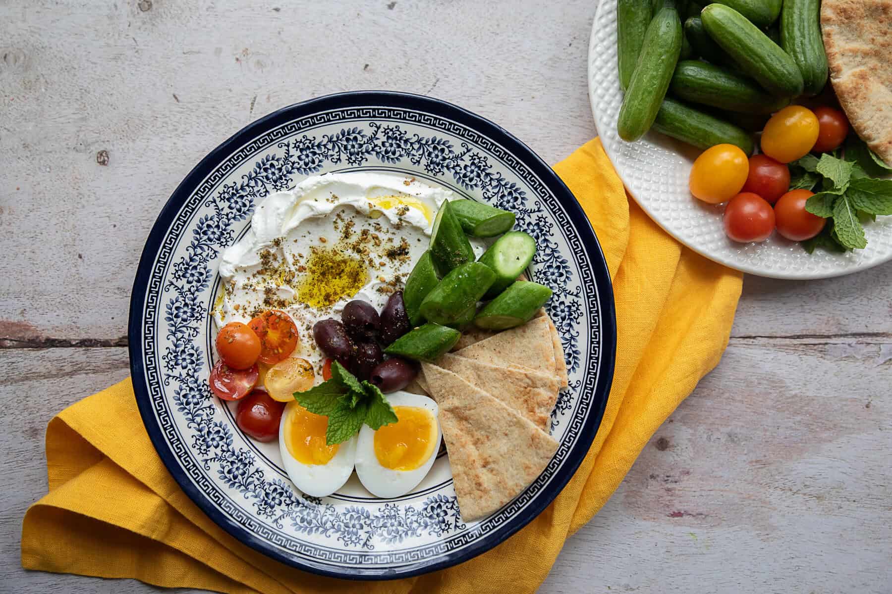 Breakfast bowls Mediterranean style on a wooden background.