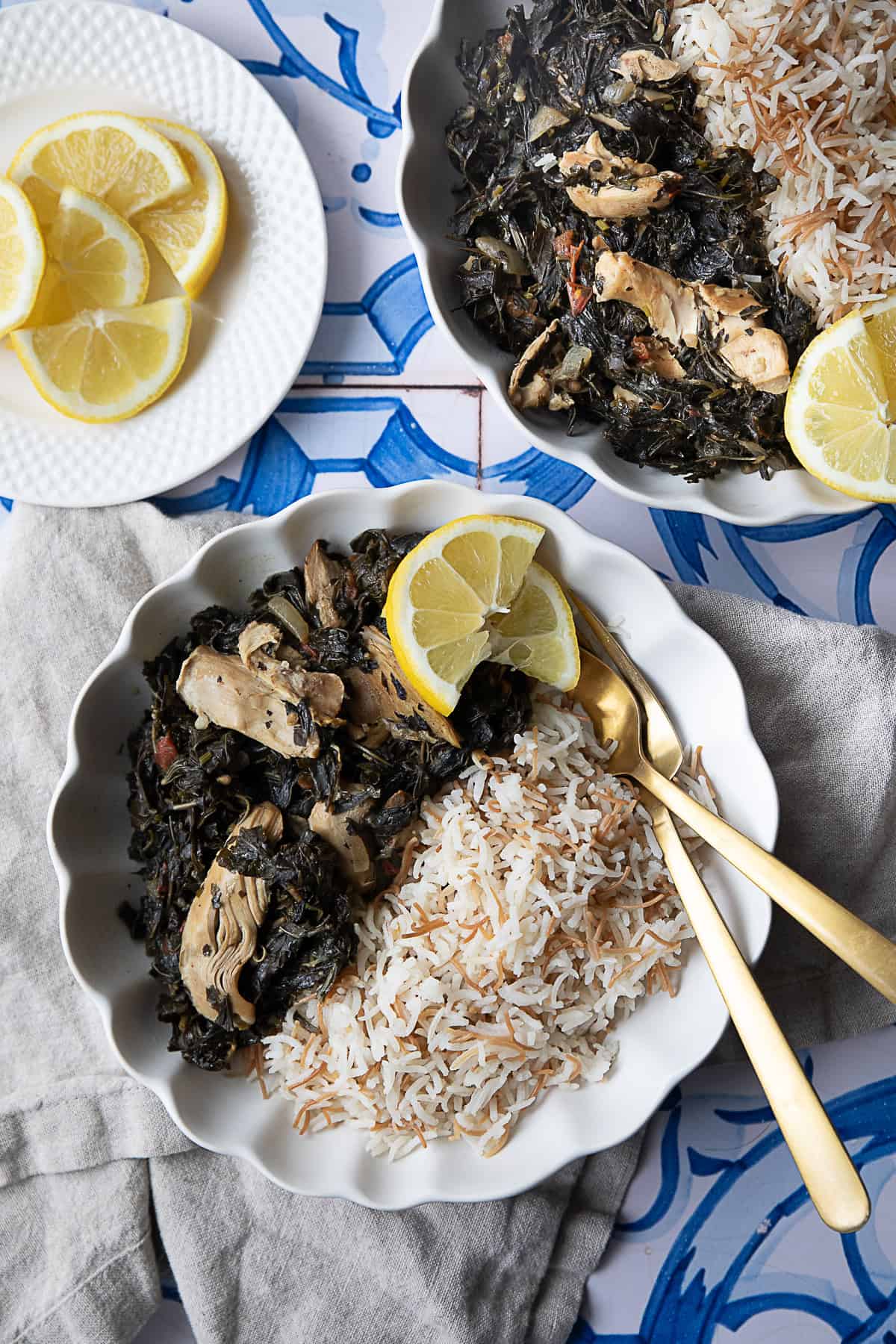 Easy Molokhia Recipe molokhia w roz (rice) served in a white bowl with lemon wedges