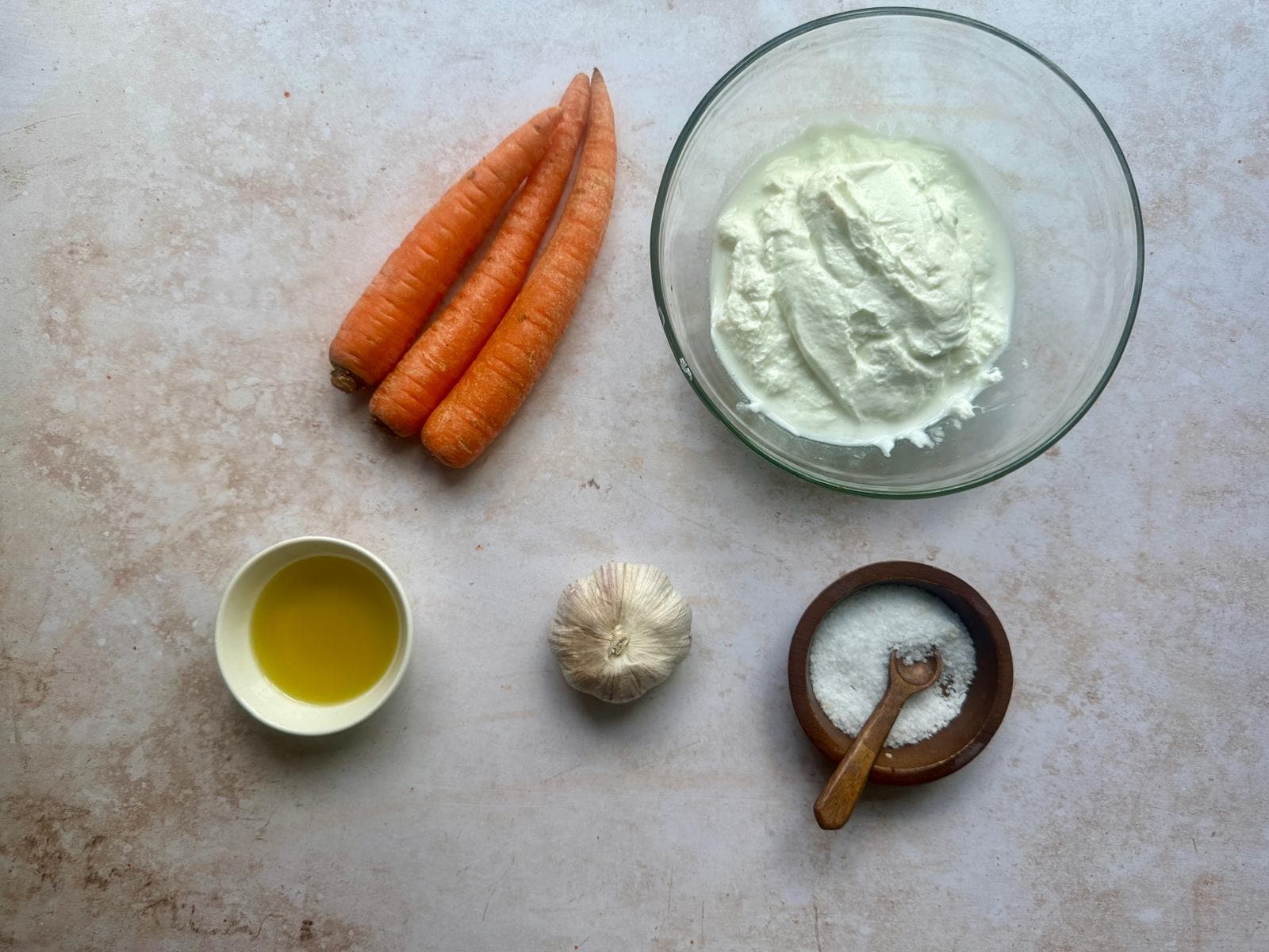 Ingredients for Turkish Carrot Salad with Yogurt Turkish carrot salad with yogurt ingredients including carrots, Greek yogurt, salt, olive oil, and garlic