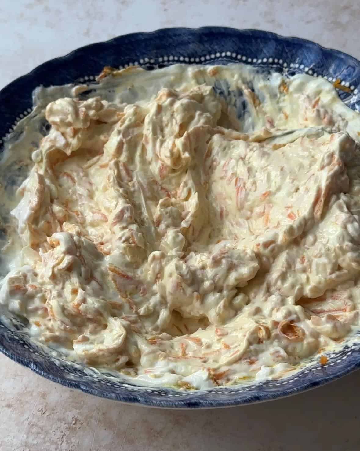 mixed carrot salad with yogurt in a bowl