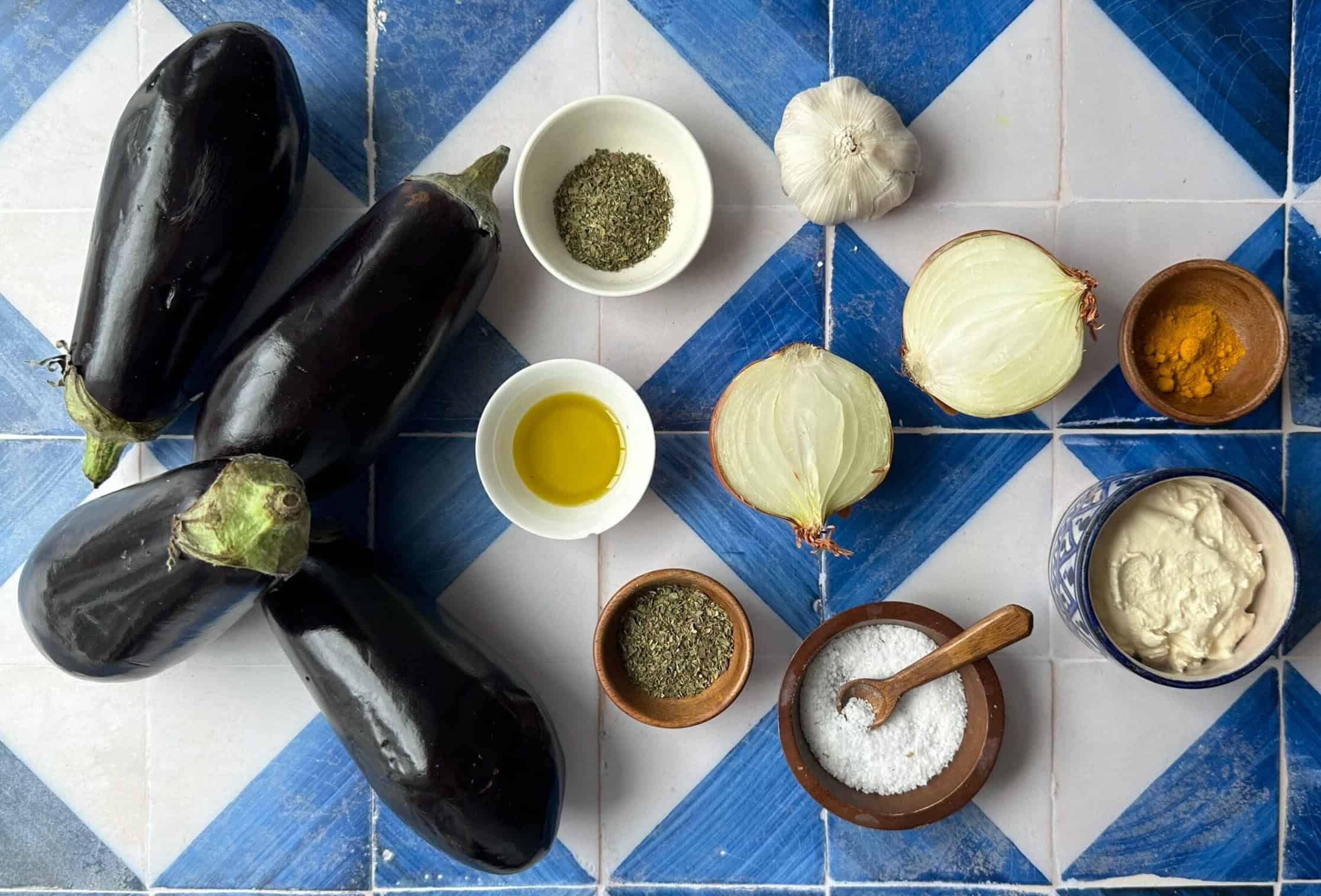 To make kashko bademjan you need eggplants, olive oil, onion, garlic, dried mint, turmeric and kashk.