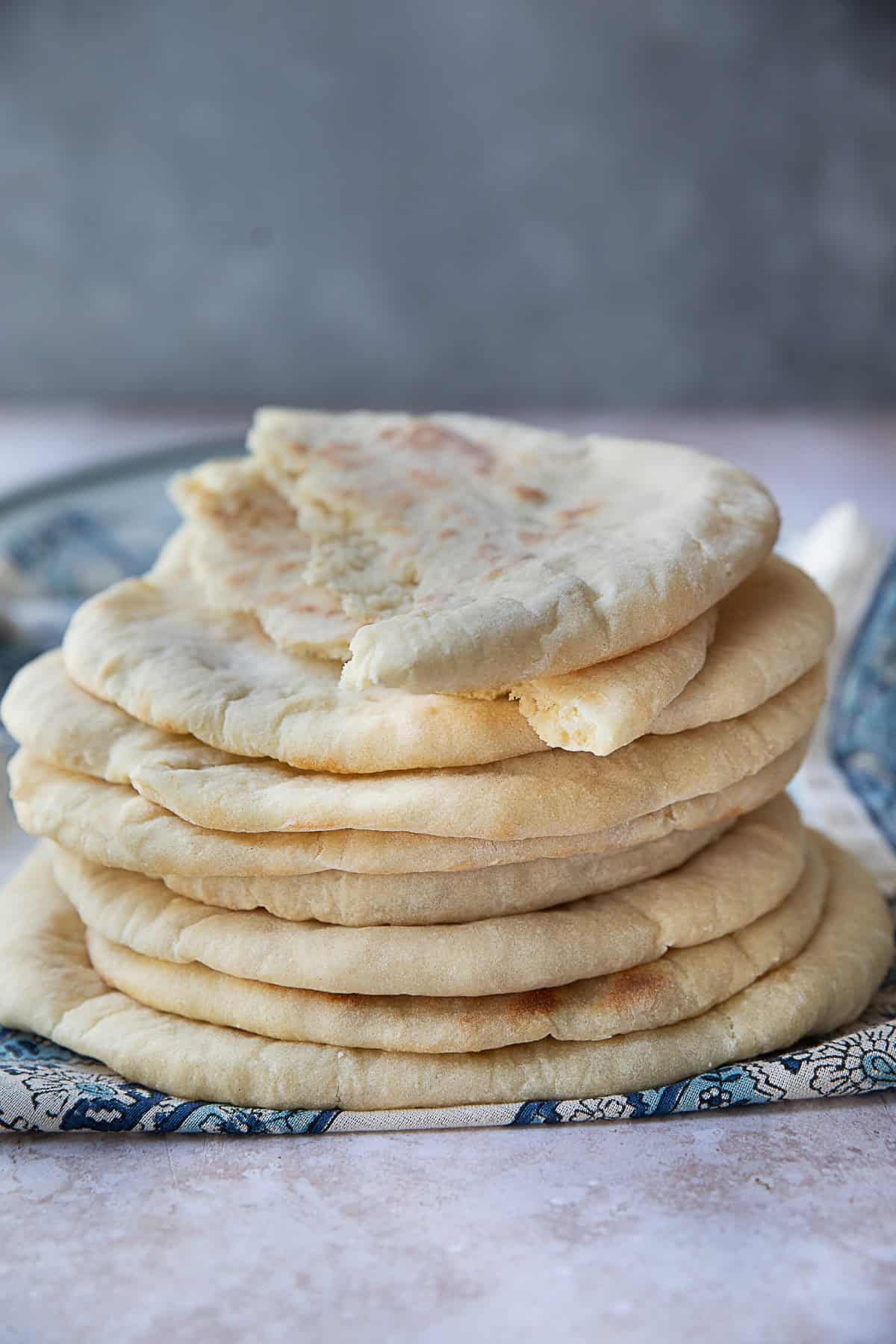 Khubz Arabi (Traditional Pita Bread) khubz Arabi or traditional pita bread stacked on top of each other