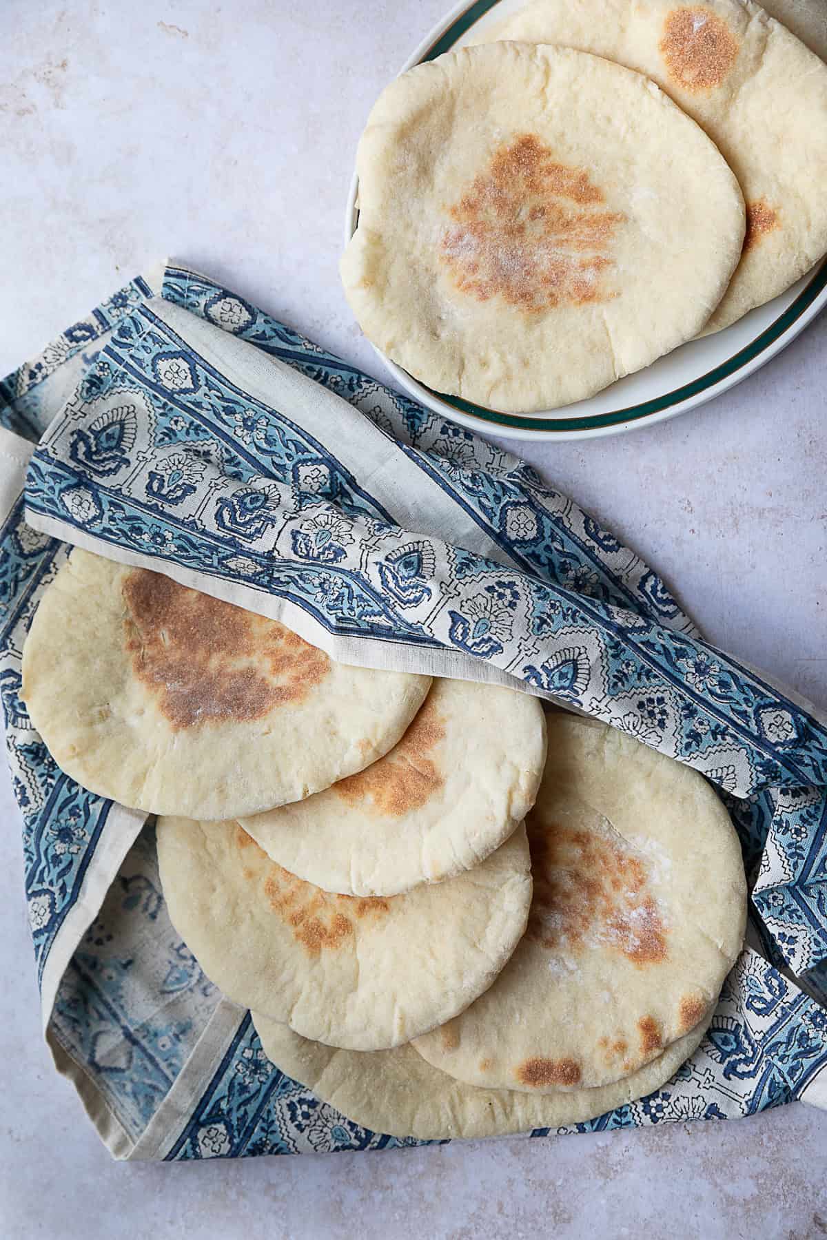 Khubz Arabi (Traditional Pita Bread) khubz Arabi (traditional pita bread) served in patterned cloth