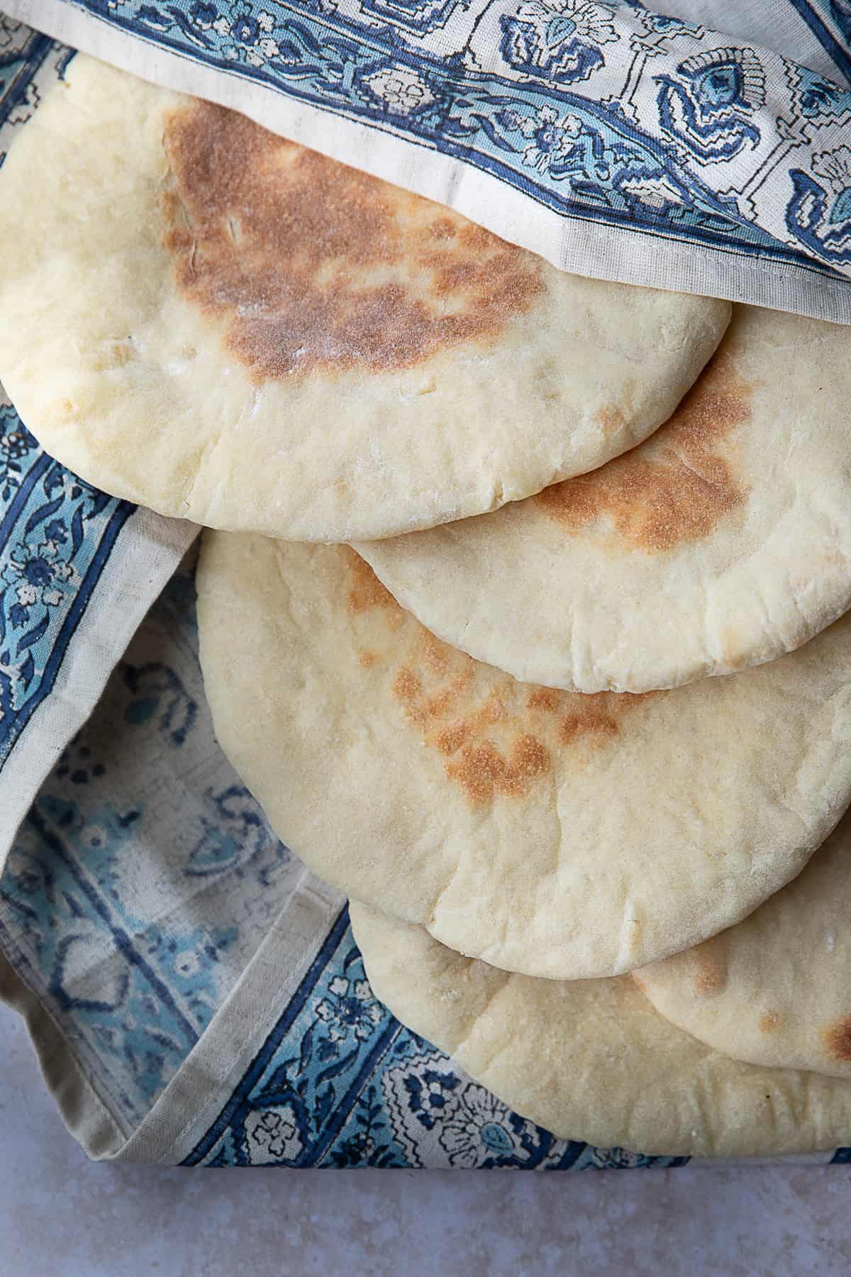 Easy Khubz Arabi Recipe khubz Arabi (traditional pita bread) served in patterned cloth