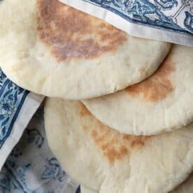 khubz Arabi (traditional pita bread) served in patterned cloth