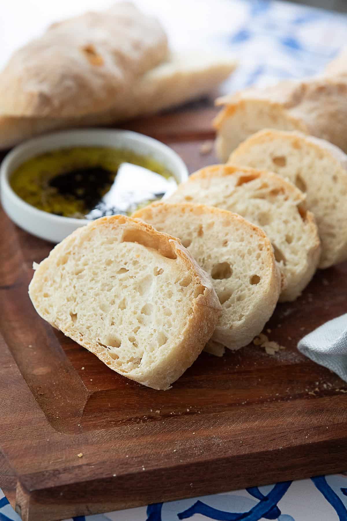 Italian Ciabatta Ciabatta bread sliced into pieces, revealing the soft, airy interior and rustic, golden-brown crust.