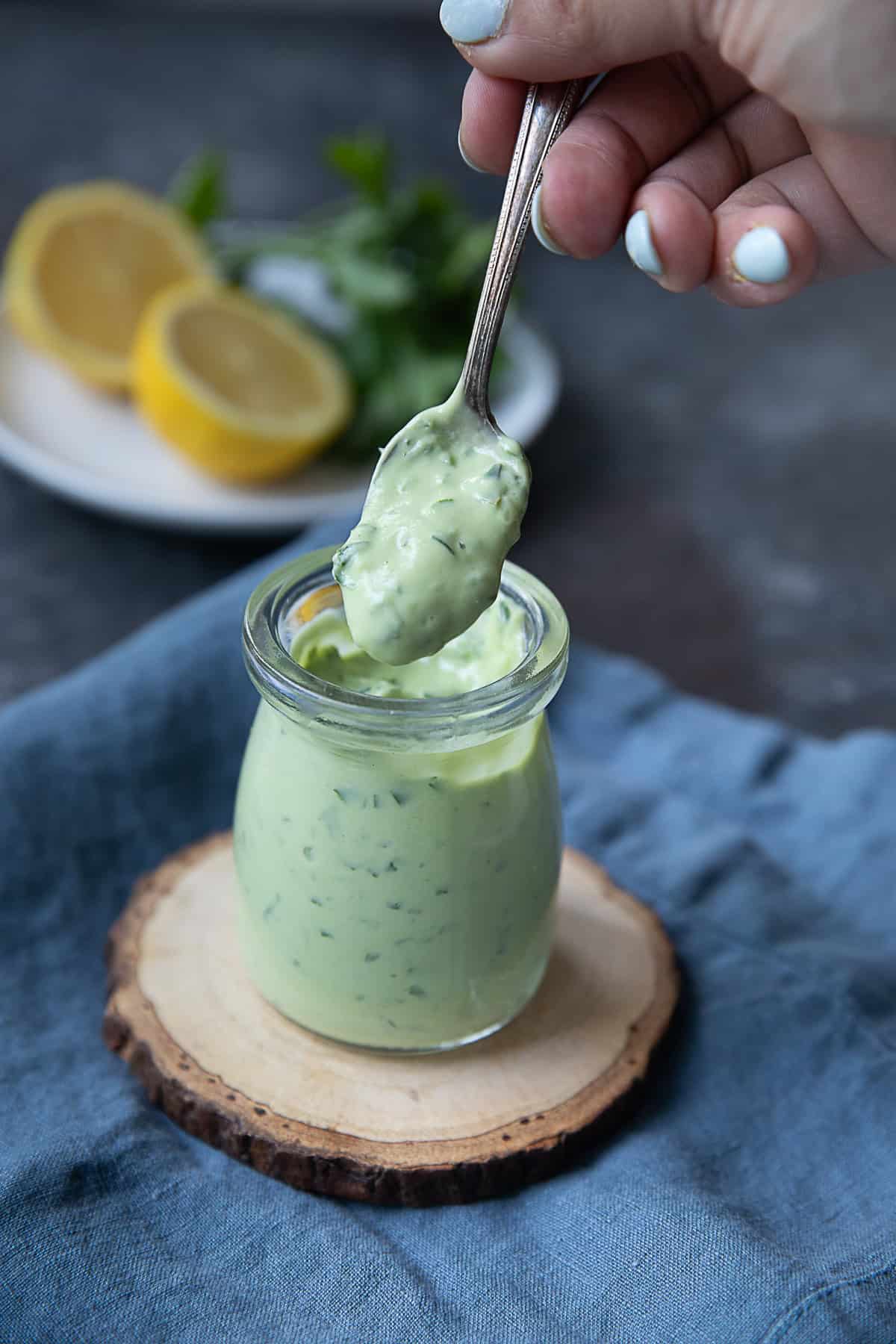 a spoon of yogurt avocado sauce