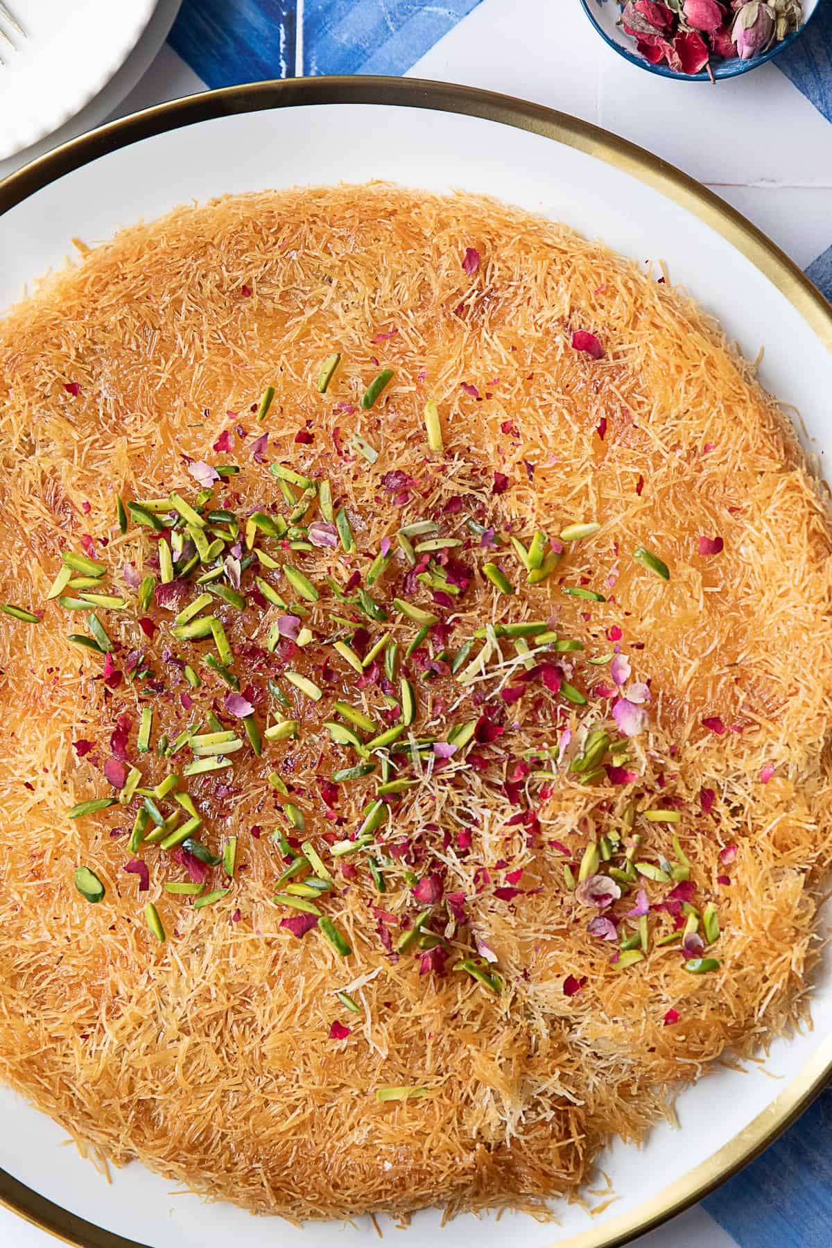 golden crispy kunafa recipe made with kataifi dough, stuffed with mozzarella cheese, and drizzled with simple syrup