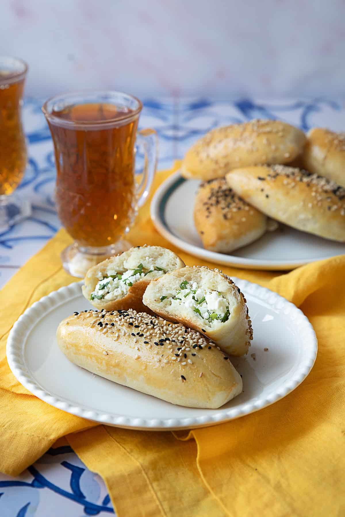 A few Turkish cheese filled pastries on a plate served with tea.
