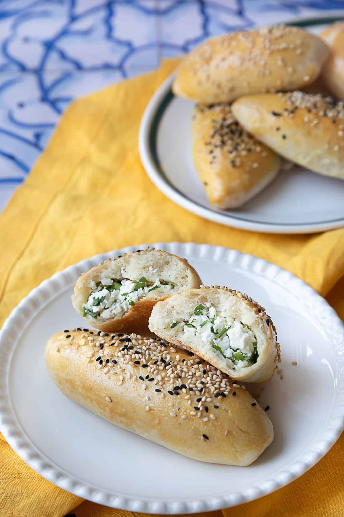 Pogaca Recipe with several fillings A plate of freshly baked golden-brown Turkish Pogaca, soft and fluffy, filled with feta cheese.