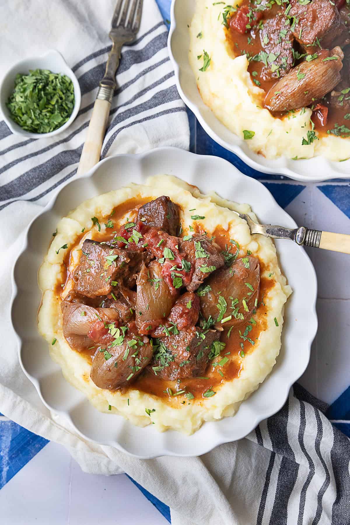 overhead shot of beef stifado served with mashed potatoes.