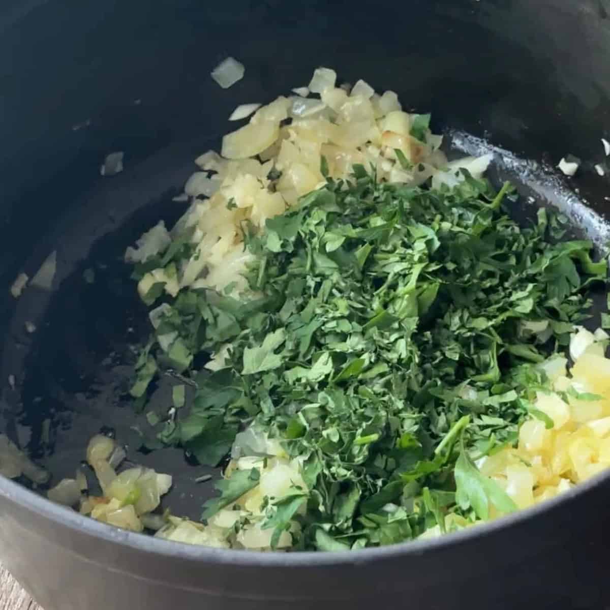 Steps to Make Bamya sautéing garlic, onion, and parsley in a pot