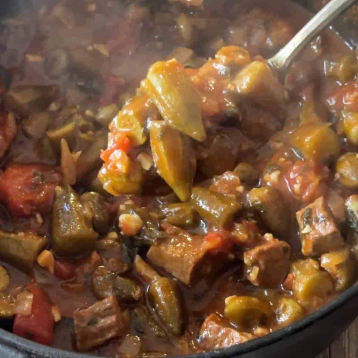a spoon of pot of simmered okra stew