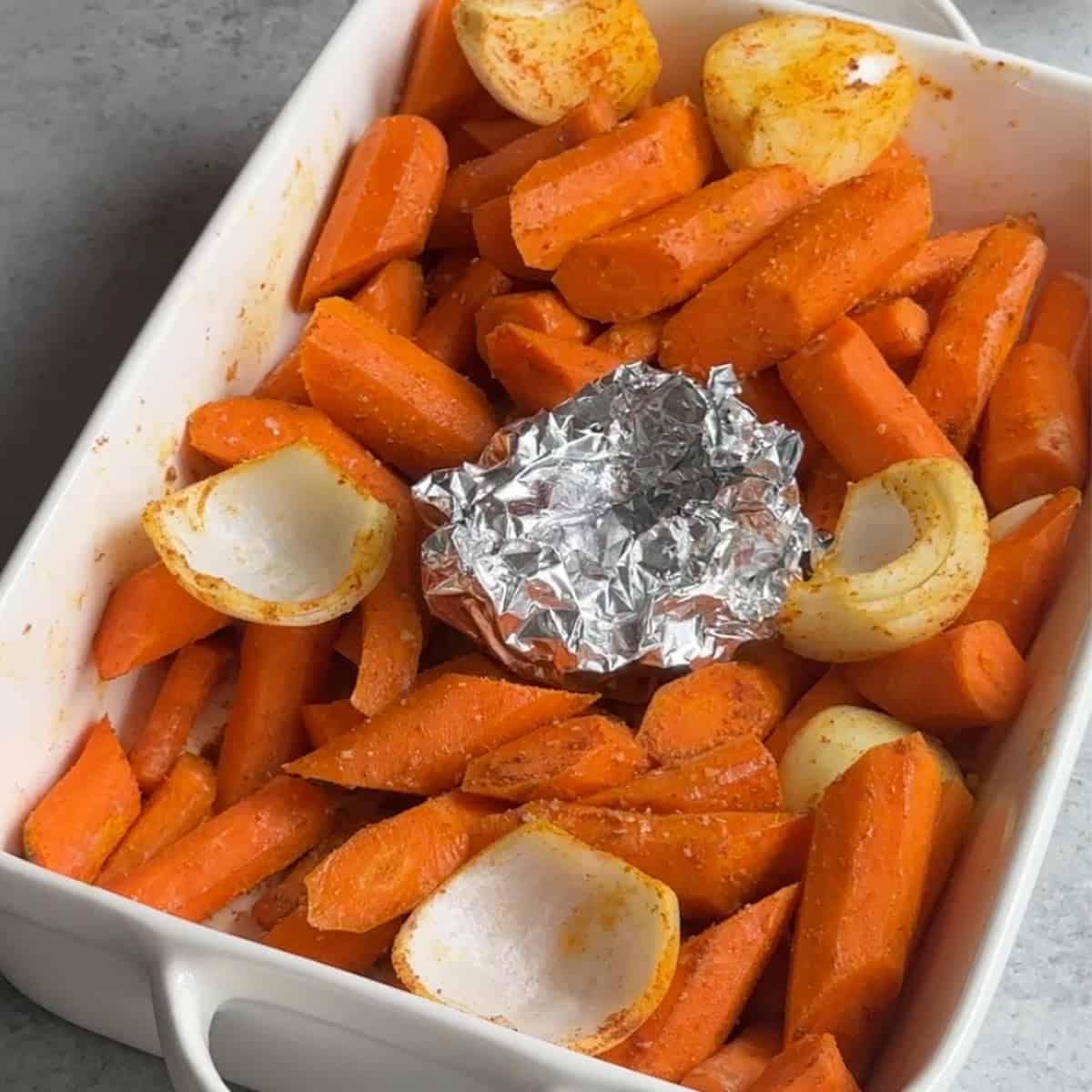 How to Make Roasted Carrot Soup place the foil wrapped garlic in he tray with vegetables.