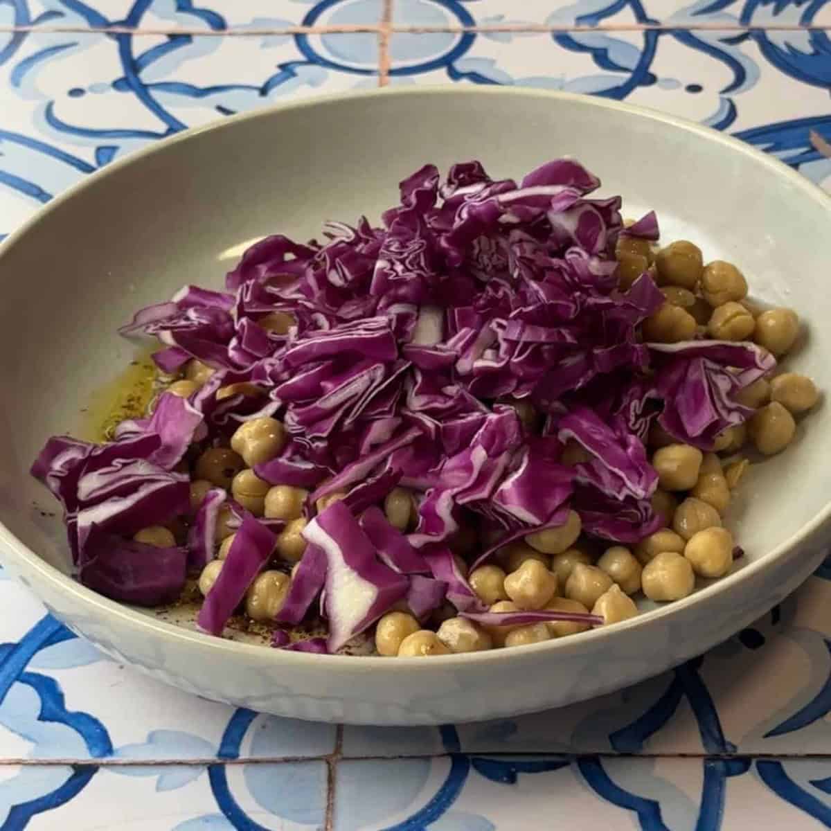 How to Make Mediterranean Chickpea Salad add strained chickpeas and red cabbage