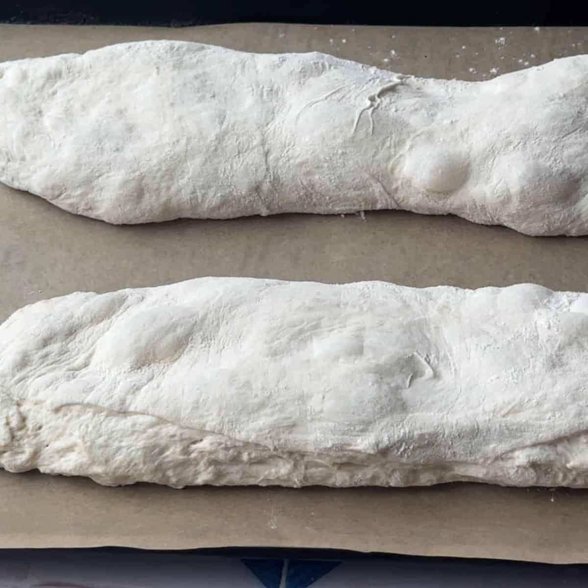 2 ciabatta doughs placed on parchment paper
