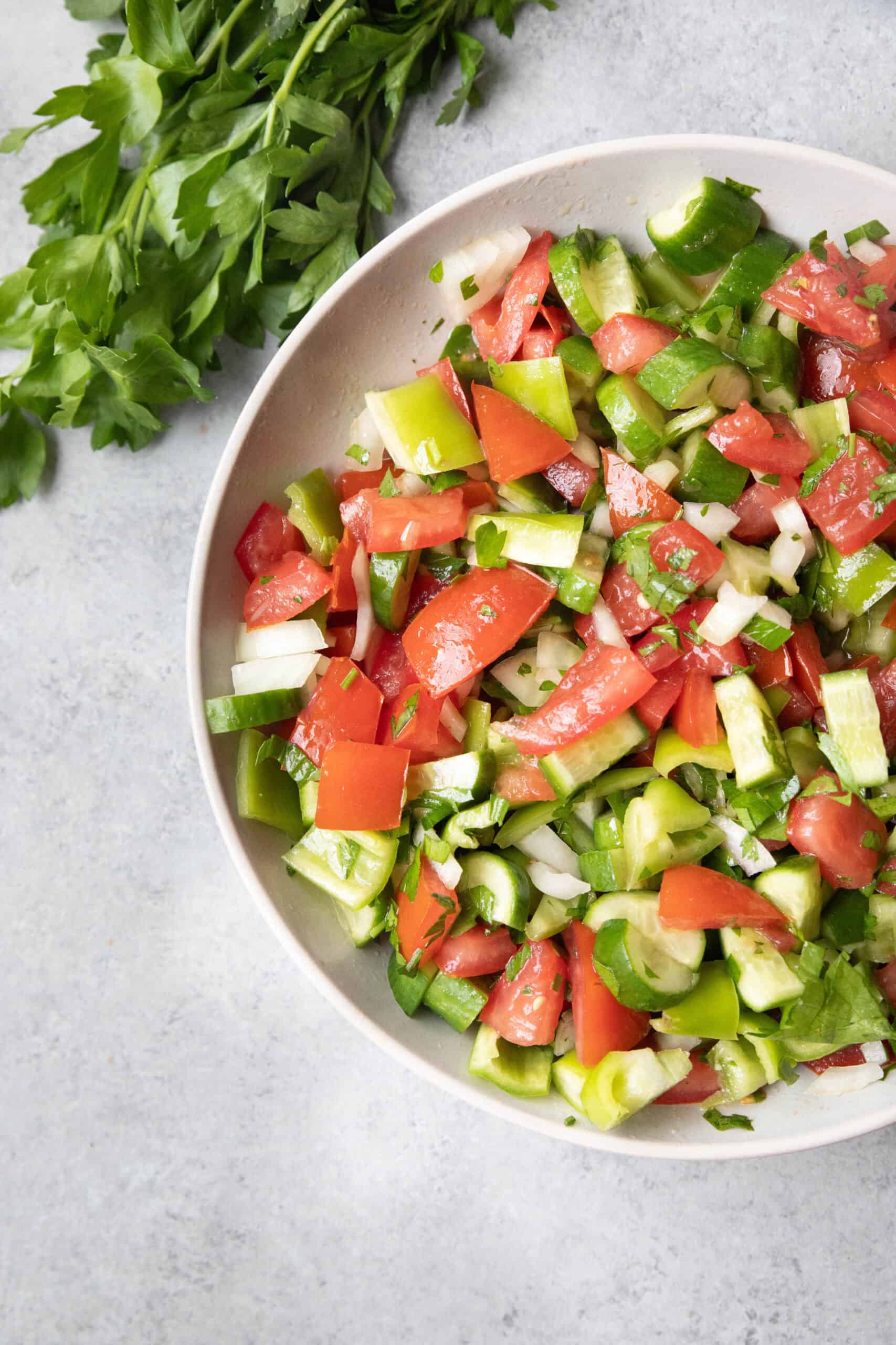 Çoban Salatası Recipe Çoban Salatası (Turkish Shepherd’s Salad) served in a white bowl with dressing