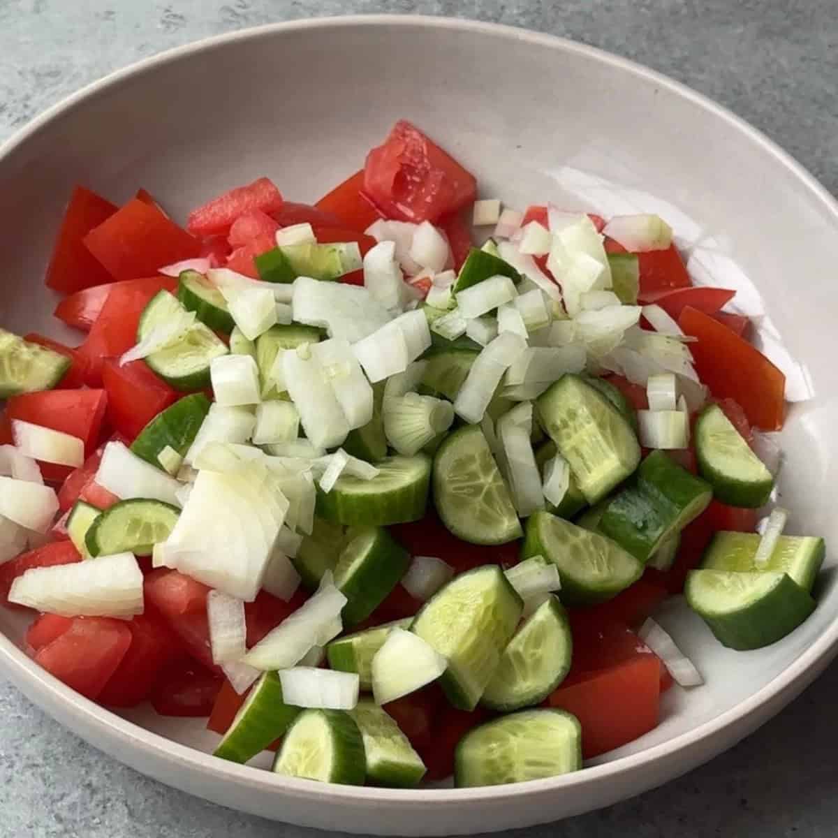 How to Make Çoban Salatası chop the veggies for coban salatsi into a bowl