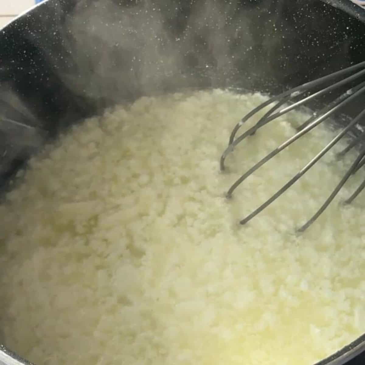 simmer yogurt and water until they separate or curdle