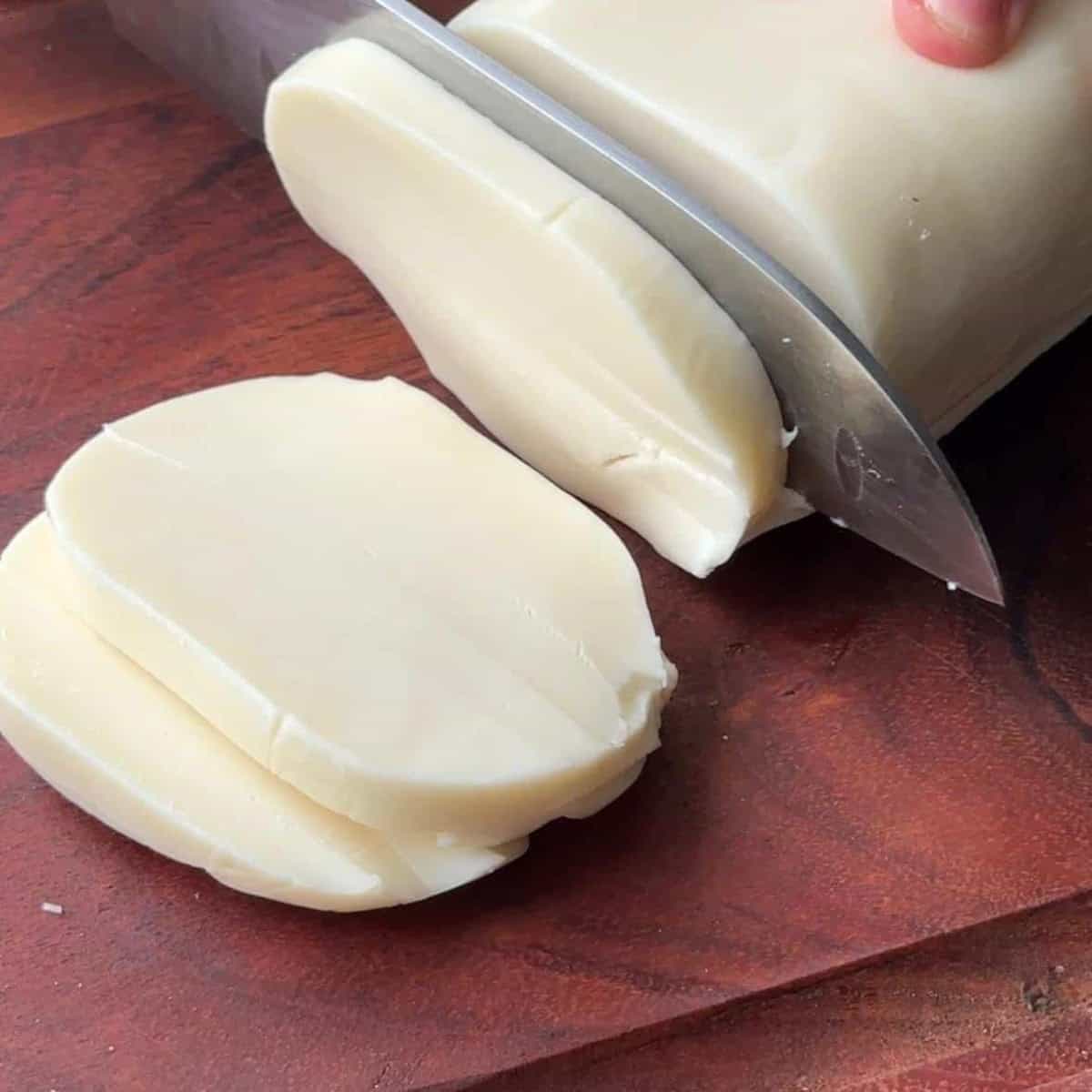 mozzarella cheese cut on a wooden board
