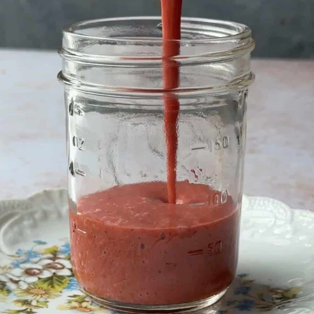 pour vinaigrette into serving jar or glass container