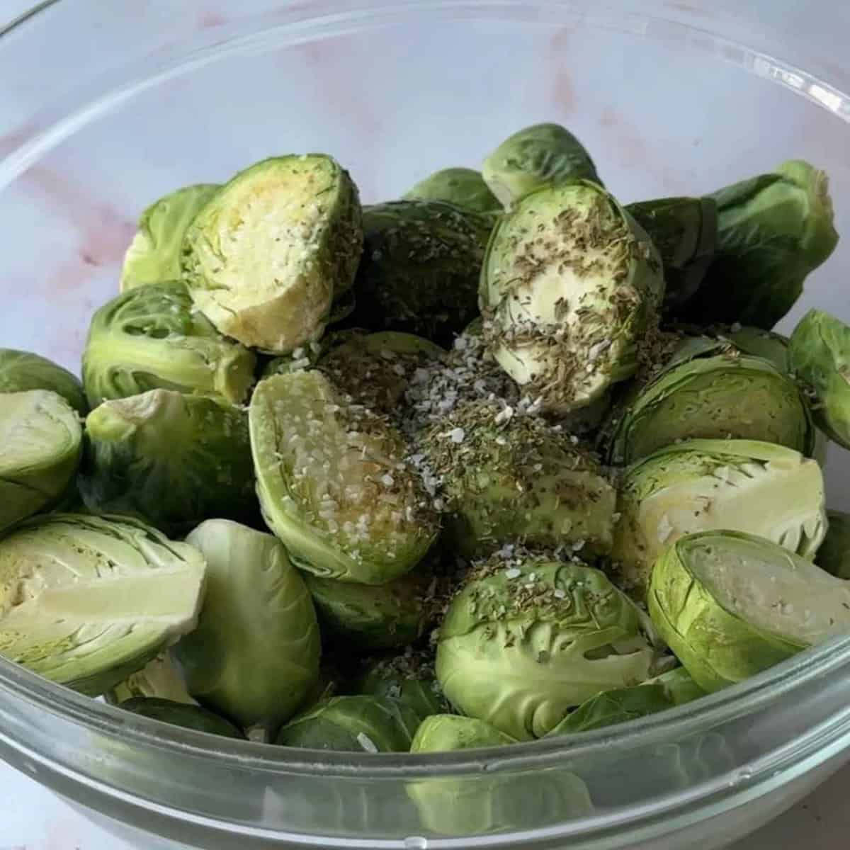 How To Make Balsamic-Glazed Brussels Sprouts Seasoned Brussel Sprouts in a bowl.
