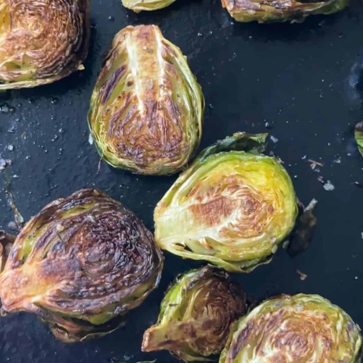 How To Make Balsamic-Glazed Brussels Sprouts Roasted Brussel Sprouts in a pan ready to be glazed.