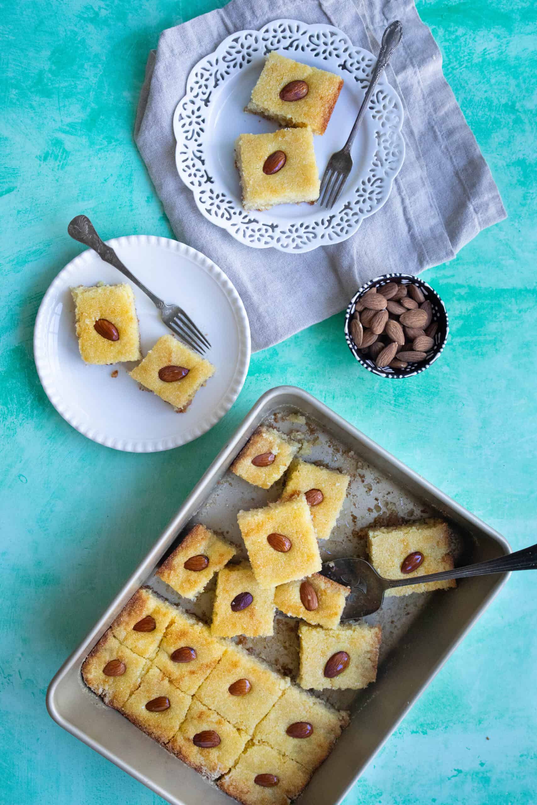 Easy Middle Eastern Semolina Cake basbousa served in a pan and in plates