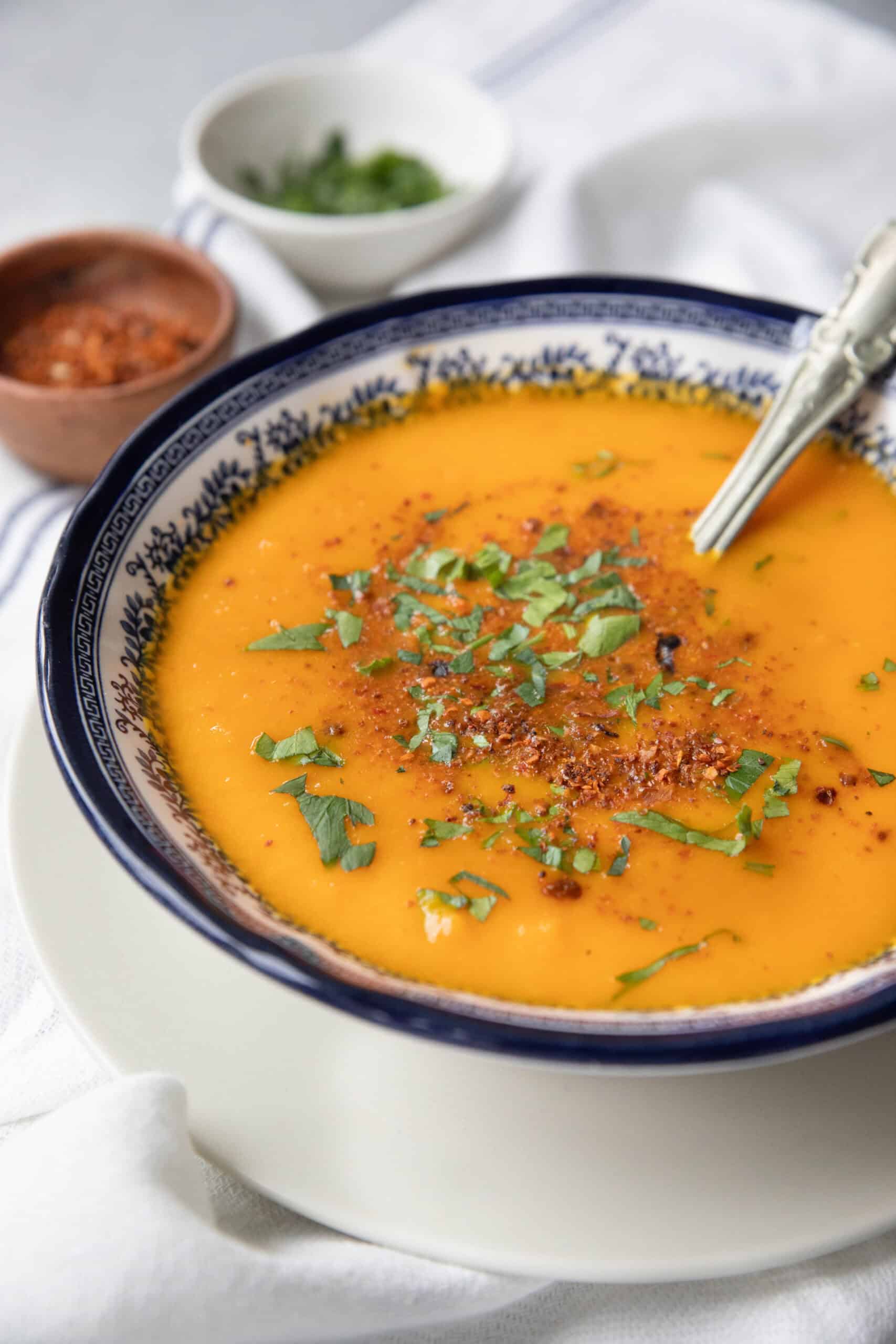 Roasted Carrot Soup roasted carrot soup in decorative bowl garnished with parsley and dill