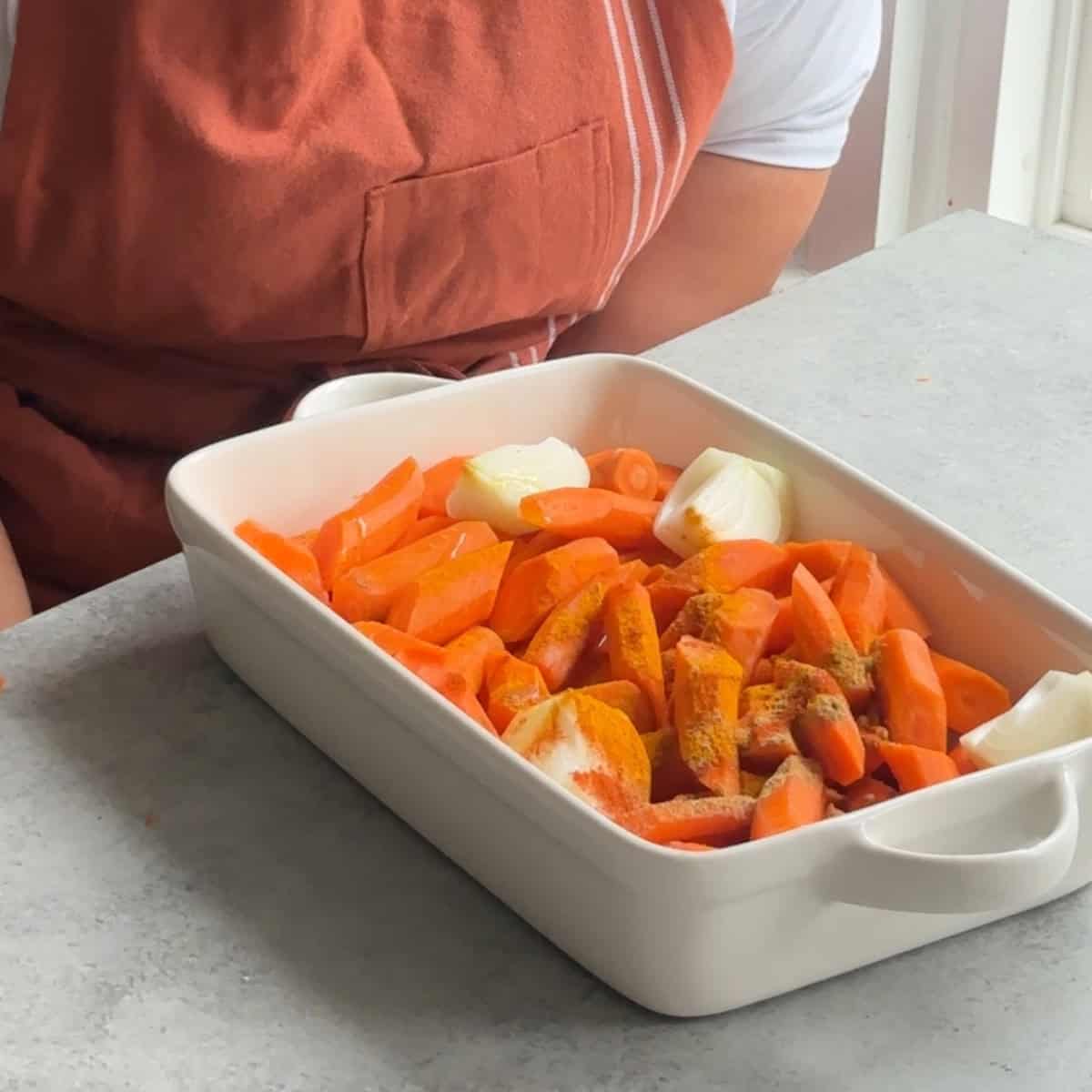 How to Make Roasted Carrot Soup cut and season veggies and place in tray
