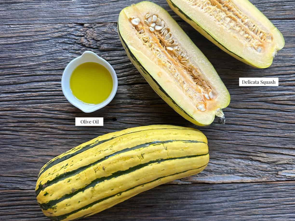 Roasted Delicata Squash Ingredients ingredients for delicata squash include delicata squash, olive oil, feta, pomegranate seeds, and chopped parsley for garnish