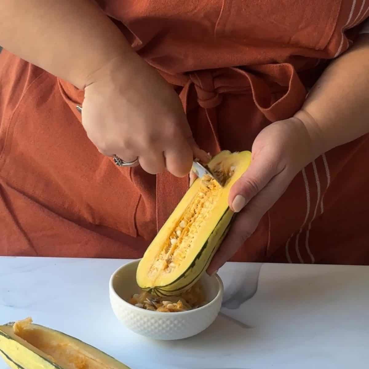 How to Make Roasted Delicata Squash slice delicata squash in half and scoop out seeds