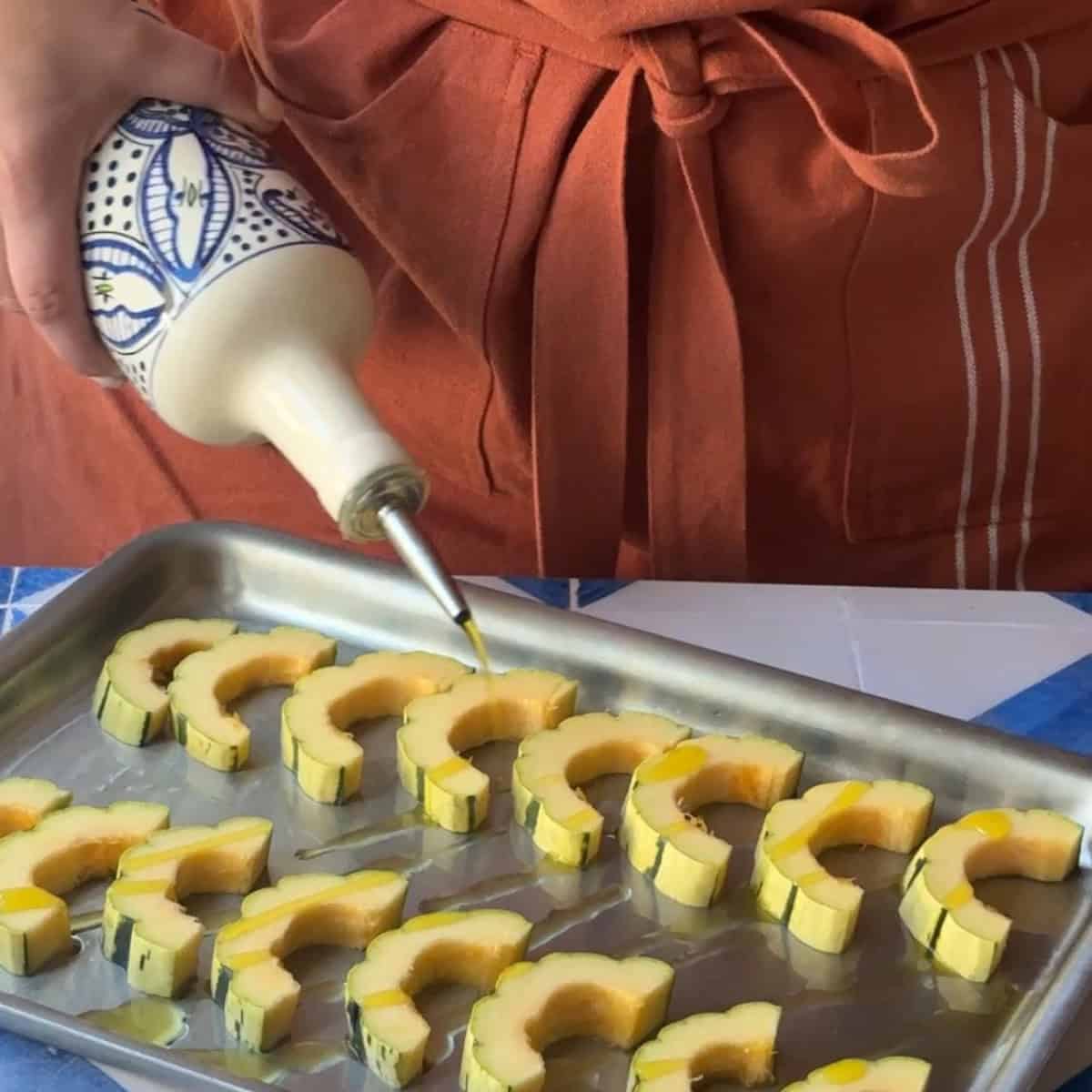 How to Make Roasted Delicata Squash arrange on baking tray and drizzle olive oil and bake