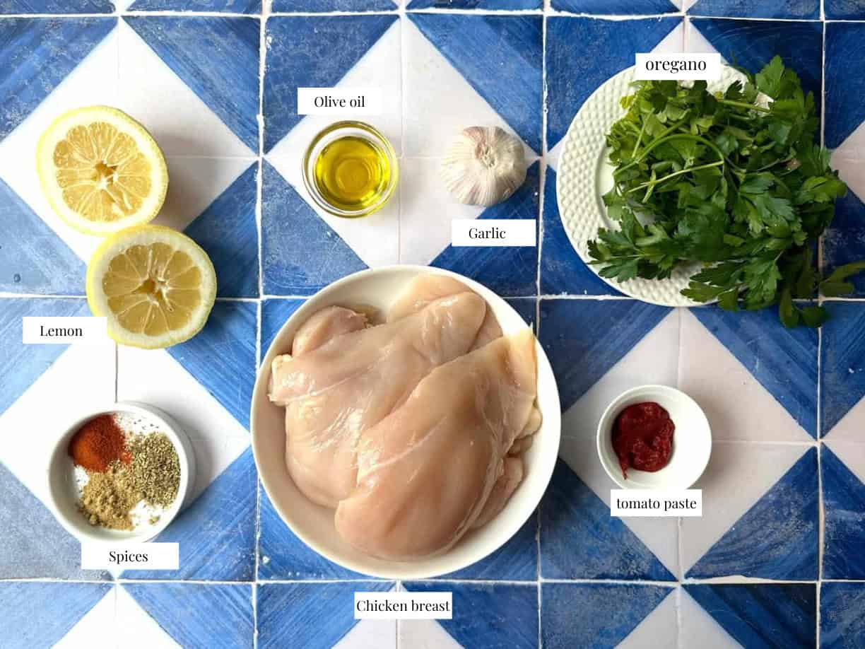 Grilled Chicken Breast Ingredients ingredients for grilled chicken breast include the sliced chicken breasts, olive oil, lemon juice, oregano, paprika, and parsley