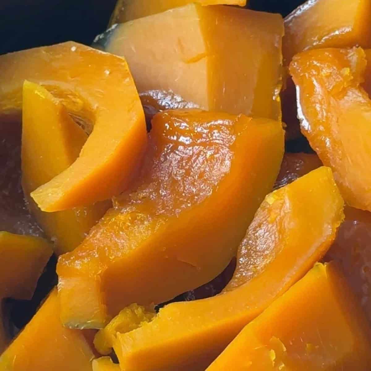 How to Make Kabak Tatlisi Cooked pumpkin pieces with a glistening caramelized surface after being simmered in sugar syrup.