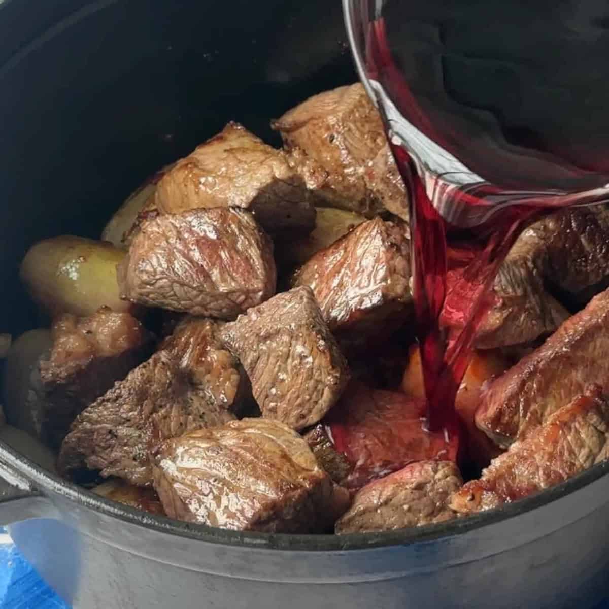 Add the tomatoes and water then cook until the beef is fully cooked.