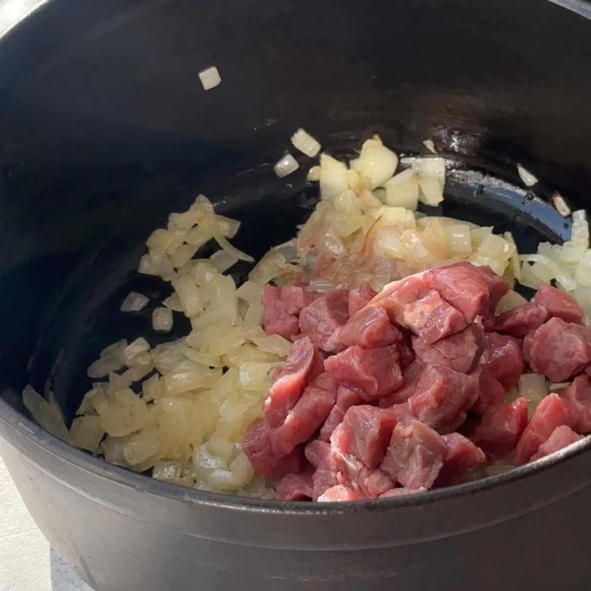 How to Make Kuru Fasulye saute onions until golden and add beef