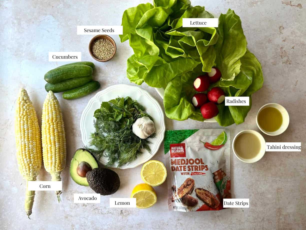 Tio make this recipe you need lettuce, corn, olive oil, radishes, avocado, cucumber, herbs and dates.