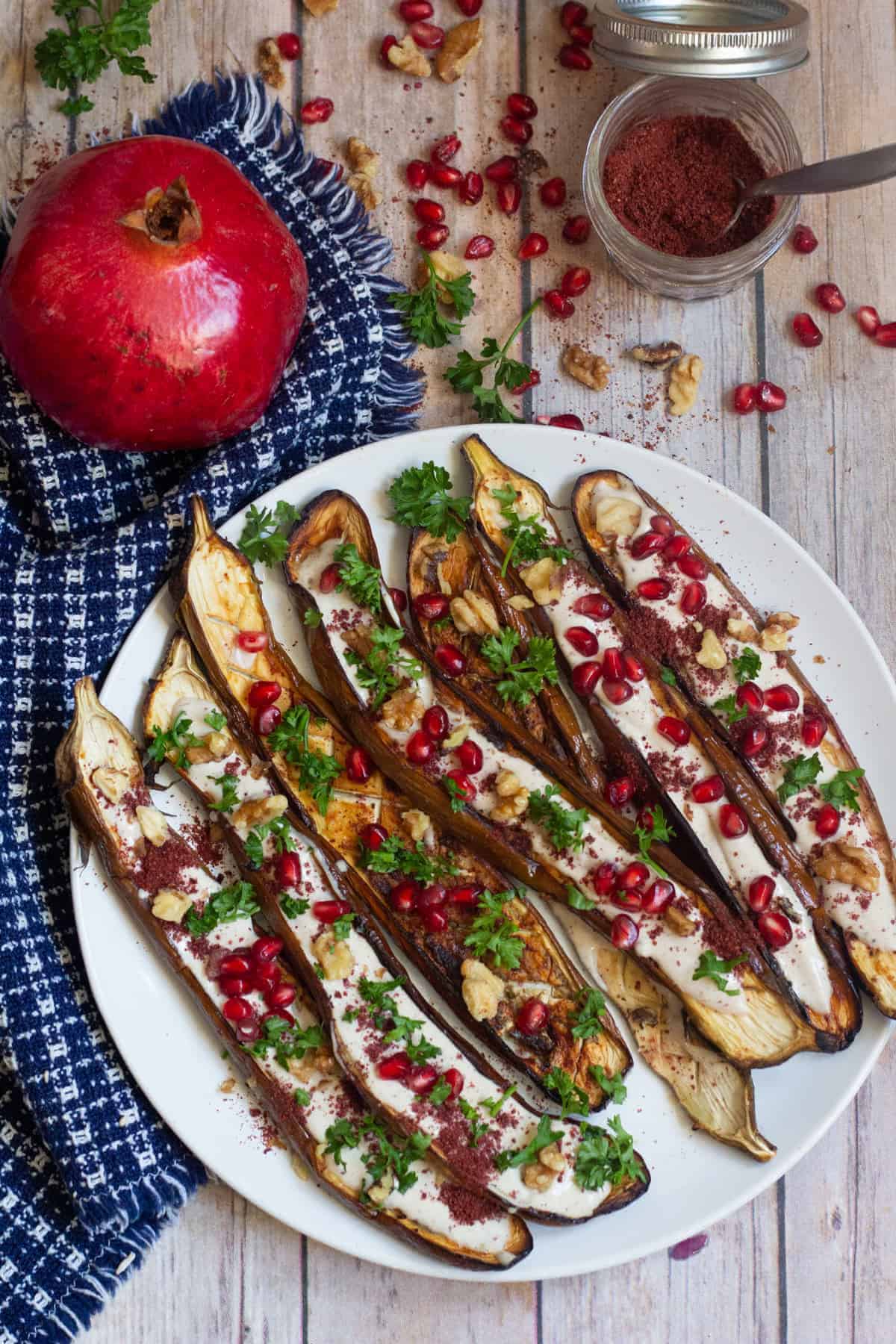 This is a great Middle Eastern eggplant recipe to always keep on hand. Perfectly roasted eggplant is served with a stunning tahini yogurt sauce and pomegranate arils. It's perfect as a side dish or an impressive appetizer!
