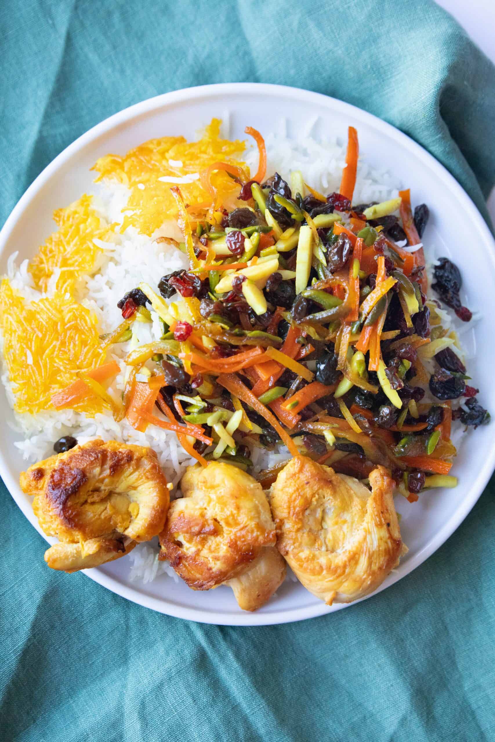 Persian Jeweled Rice Recipe Overhead shot of Persian jeweled rice with chicken and tahdig.