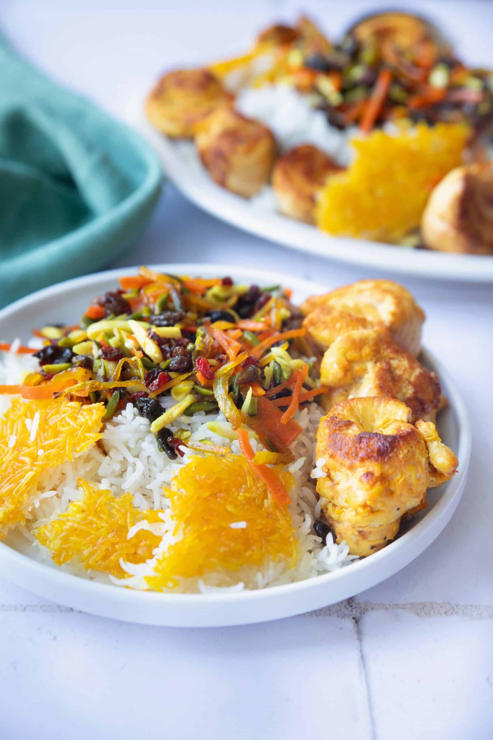 Saffron Rice with Fruits and Nuts a plate of jeweled rice on a white background.