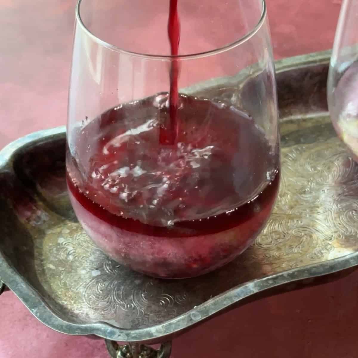 gently pour seltzer over the ice to create the pomegranate mocktail