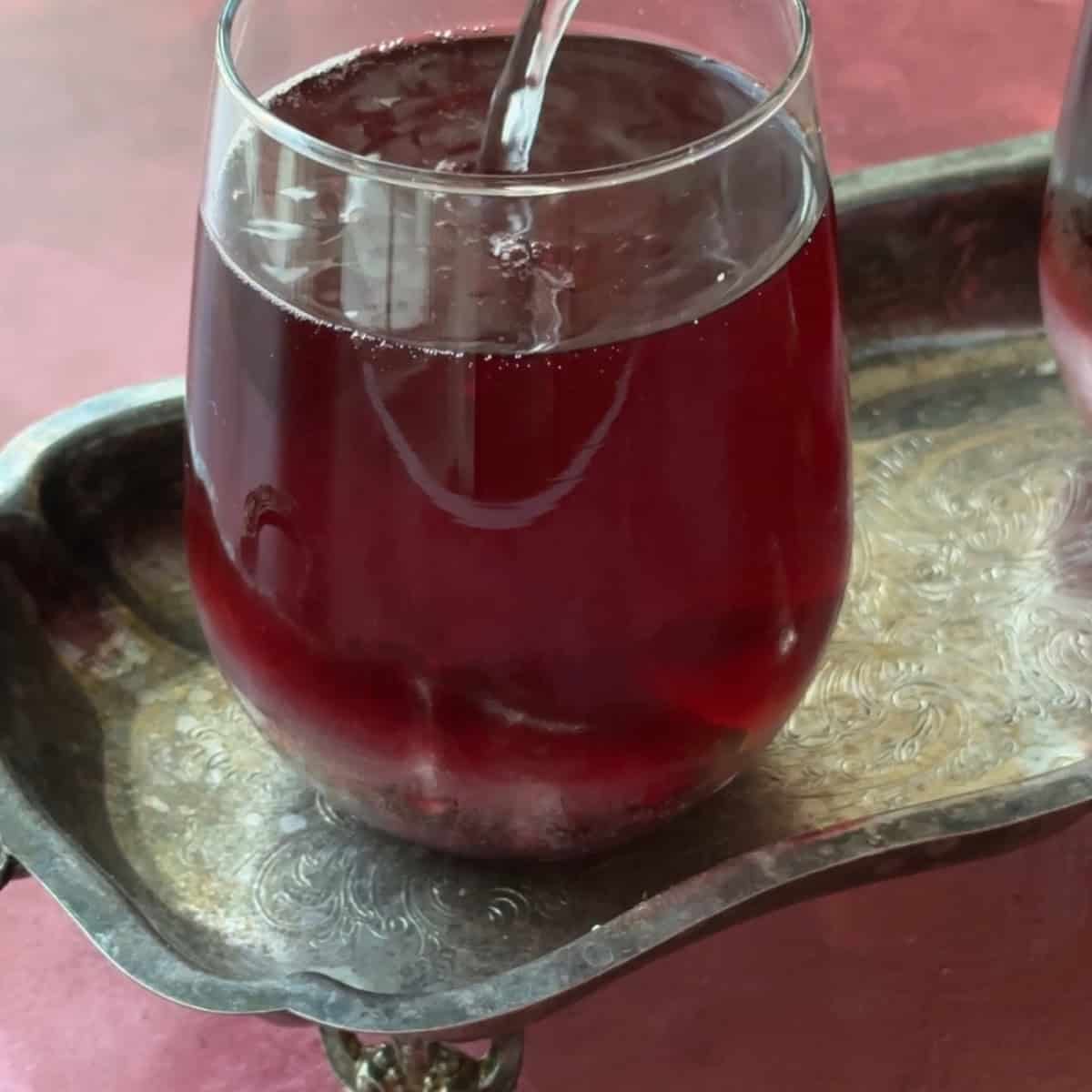 How to Make Pomegranate Mocktails lightly stir to mix and serve the pomegranate mocktail