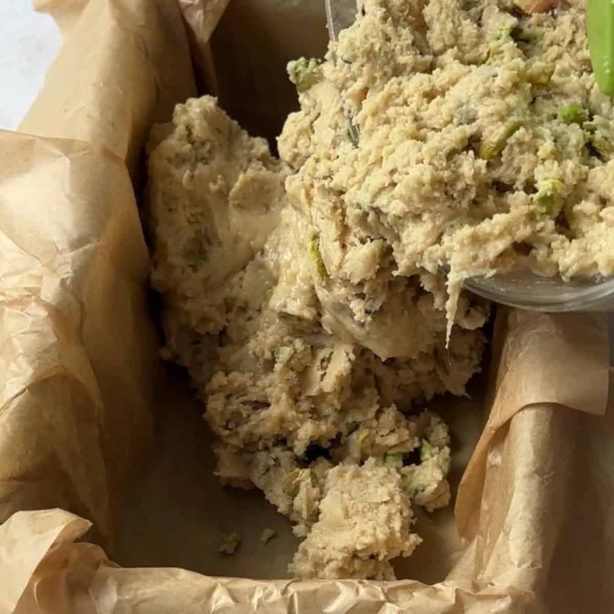 how to make tahini halva pour halva mixture into a pan with parchment paper