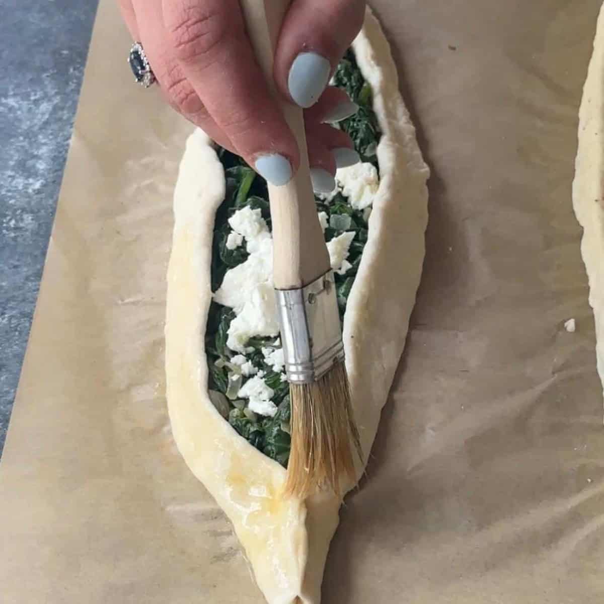 How To Make Turkish Pide brush the edges of the dough with an egg wash